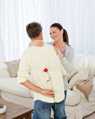 Lovely woman receiving a rose from her boyfriend