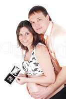 Couple holding a sonogram of their child