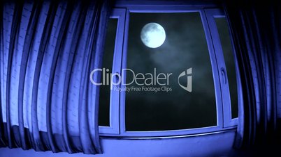 Looking through spooky windows at timelapse full moon