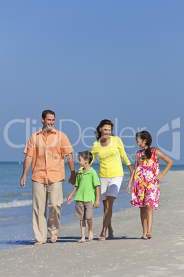Mother, Father and Children Family Walking At Beach