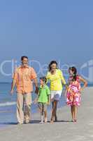 Mother, Father and Children Family Walking At Beach