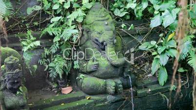 Ganesh statue in monkeys forest on Bali , Indonesia