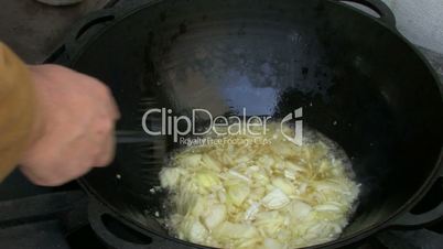 Boiling melted fat with onion