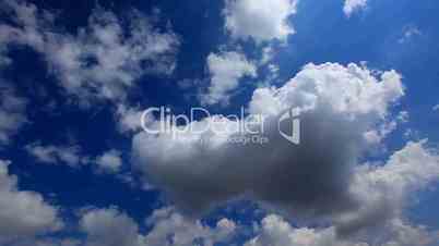 white fluffy clouds over blue sky