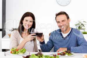 Portrait of a happy couple drinking red wine at lunch