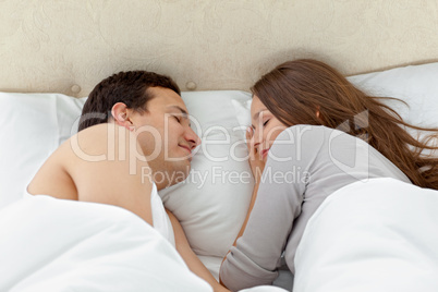 Serene couple sleeping together on their bed