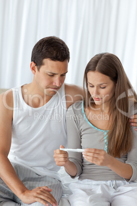 Young couple waiting for the result of the pregnancy test