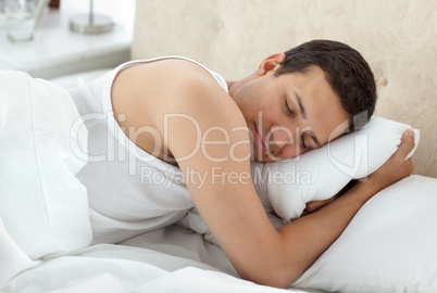 Cute man sleeping peacefully on his bed
