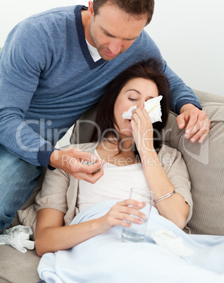 Handsome man taking care of his sick girlfriend