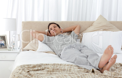Tranquil man lying on his bed