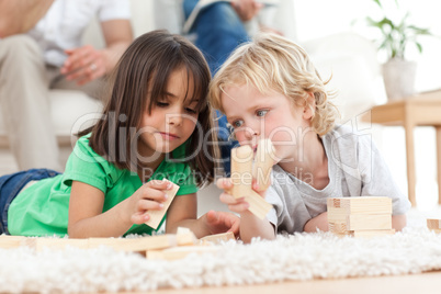 Little boy and girl playing with dominoes together