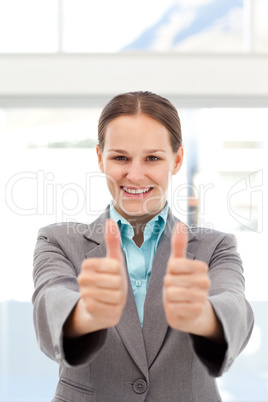 Proud businesswoman doing thumbs up