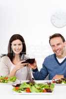 Lovely couple drinking red wine while having lunch