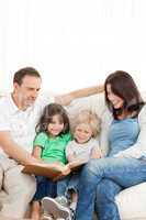 Cheerful family looking at a photo album together