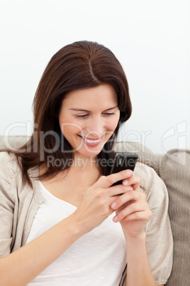 Happy woman sending a message with her cellphone