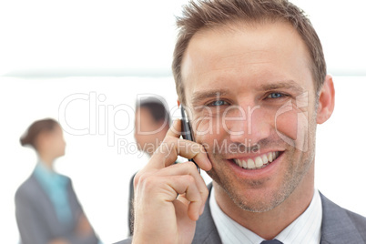Portrait of a businessman on the phone during a meeting