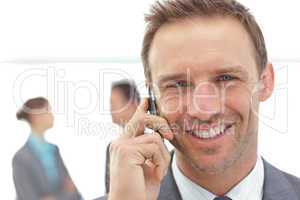 Portrait of a businessman on the phone during a meeting