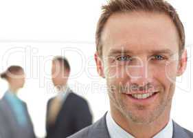 Cheerful businessman posing in front of his team while working