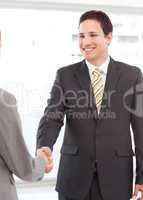 Successful businessman shaking hands with a young businesswoman
