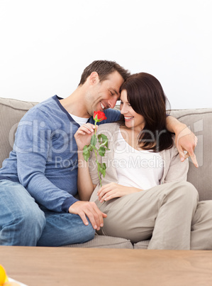 Enamored couple sitting together on the sofa