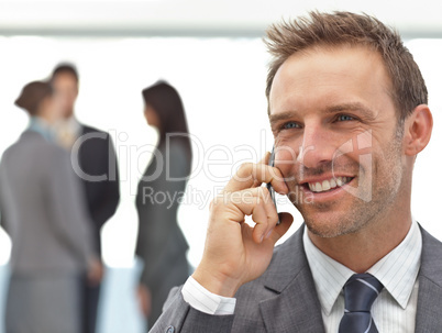 Happy businessman on the phone during a meeting