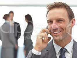 Happy businessman on the phone during a meeting