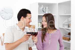 Lovely couple giving a toast with red wine