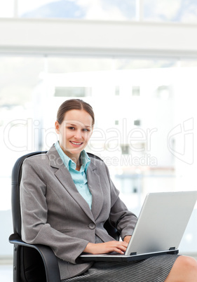 Pretty businesswoman working at her desk with a laptop