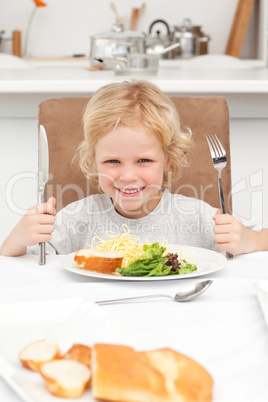 Portrait of a little boy ready to eat pasta and salad