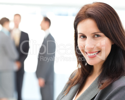 Charismatic businesswoman posing in front of her team