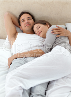 Peaceful man thinking while relaxing with his girlfriend