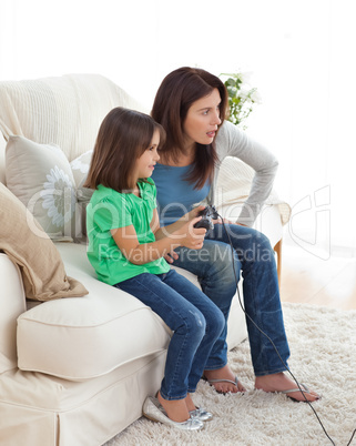 Concentrated mom and daughter playing video games