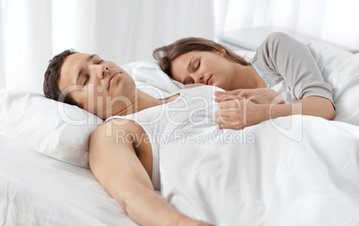 Cute couple sleeping together on their bed