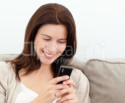 Attractive woman reading a sms on  her mobile phone
