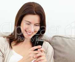 Attractive woman reading a sms on  her mobile phone