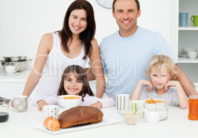 Cheerful family having breakfast together in the kitchen