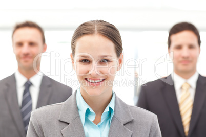 Cheerful businesswoman standing in front of two businessmen