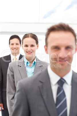 Young businesswoman posing with two businessmen in a row