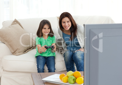 Mom and daughter playing video games together