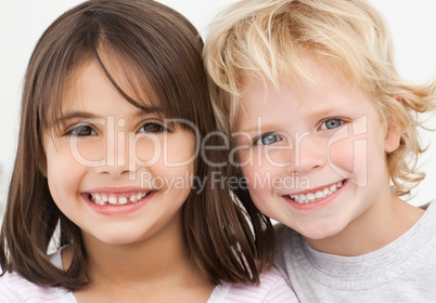 Portrait of two happy children in the kitchen