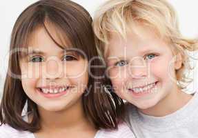 Portrait of two happy children in the kitchen