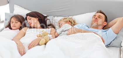 Cute family sleeping together
