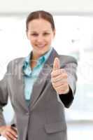 Young female executive doing a thumbs up