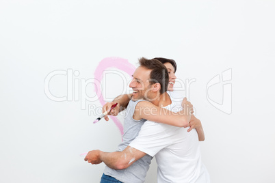 Lovely couple hugging while renovating their bedroom