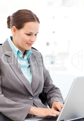 Young businesswoman working on the laptop in her office