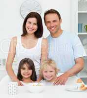 Lovely family during breakfast in the kitchen