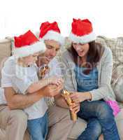 Happy parents with thir opening crackers together