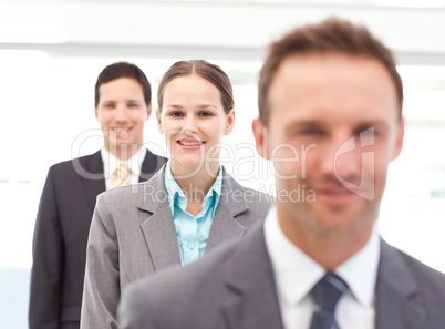 Pretty businesswoman posing with her partners in a row