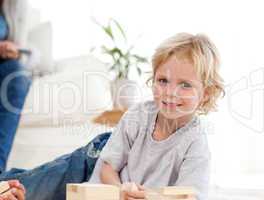 Cute child playing with dominoes in the living room