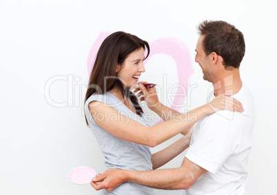 Happy woman hugging her boyfriend after drawing a heart